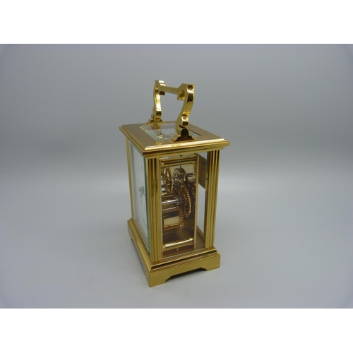 847 - A Woodford brass and four glass sided carriage clock, with presentation plaque