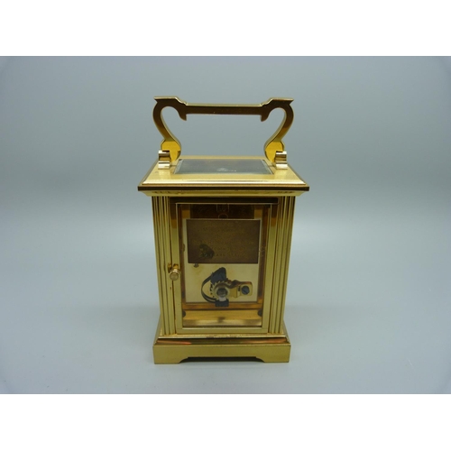 847 - A Woodford brass and four glass sided carriage clock, with presentation plaque