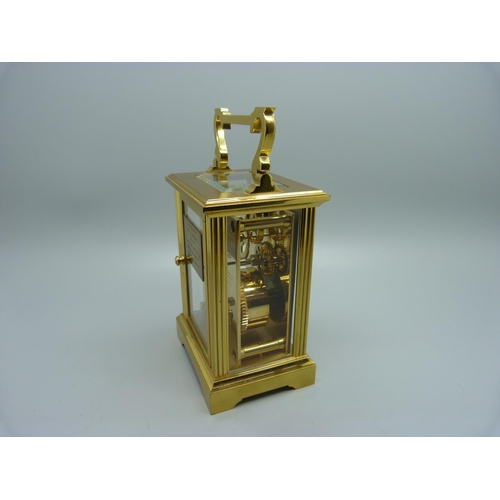 847 - A Woodford brass and four glass sided carriage clock, with presentation plaque