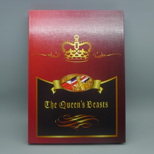 851 - The Queen's Beasts, ten silver plated heraldic coins in folder with certificate of ownership