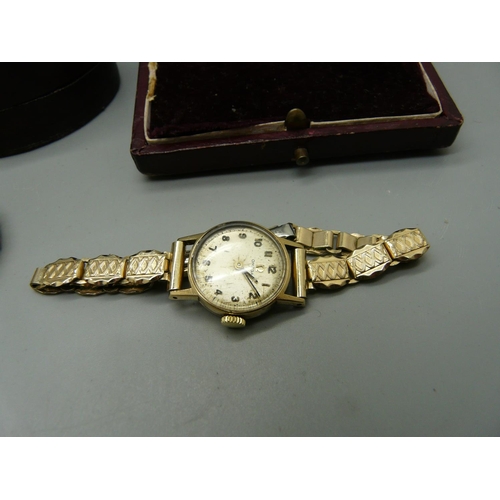 904 - Three lady's 9ct gold wristwatches on plated bracelets, including one Omega