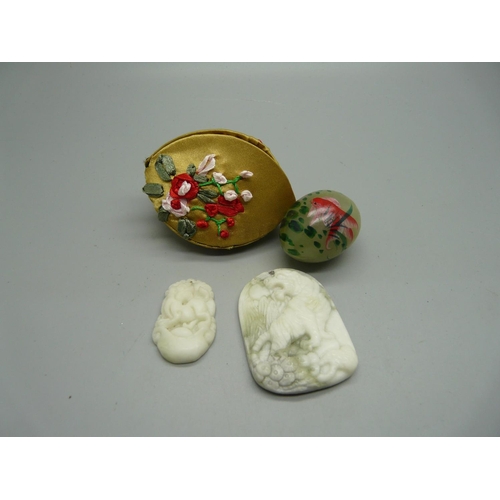 908 - Two Oriental carved pendants and a decorated 'egg'