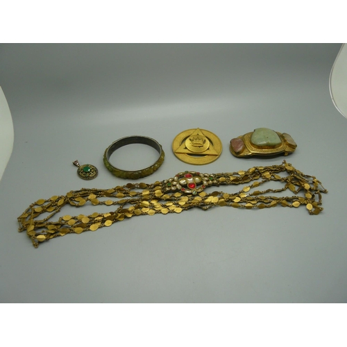 913 - A stone set pendant, a stone set buckle, a belt, etc.