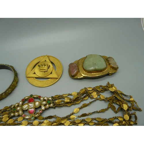 913 - A stone set pendant, a stone set buckle, a belt, etc.