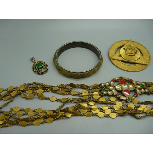 913 - A stone set pendant, a stone set buckle, a belt, etc.