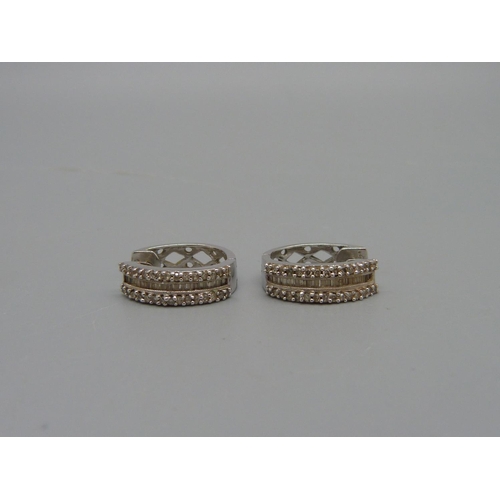 954 - A pair of 10ct white gold and diamond earrings, 3.3g