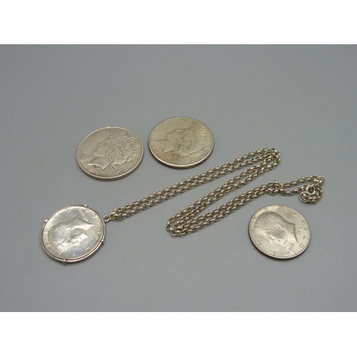 965 - Two U.S. dollars, 1922 and 1923, and two U.S. half dollars, one with mount and silver chain