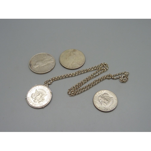 965 - Two U.S. dollars, 1922 and 1923, and two U.S. half dollars, one with mount and silver chain