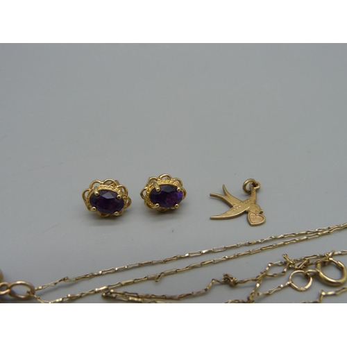 971 - A pair of 9ct gold earrings, a 9ct gold bird charm, a 9ct gold back and front heart shaped locket on... 