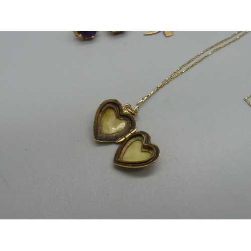 971 - A pair of 9ct gold earrings, a 9ct gold bird charm, a 9ct gold back and front heart shaped locket on... 