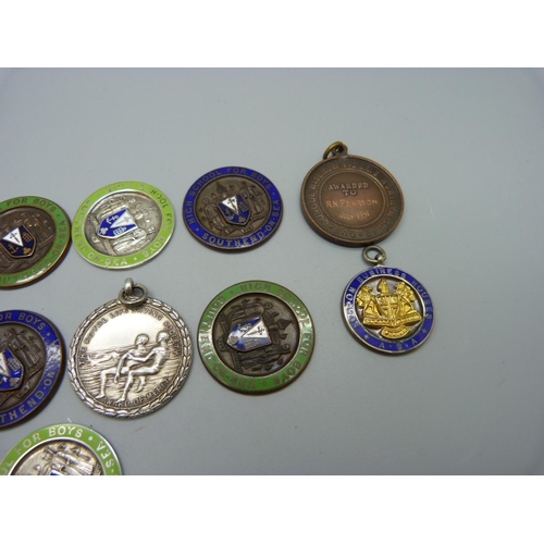 989 - A 1930's silver Life Saving medallion, three silver and enamel medallions and nine other medallions,... 