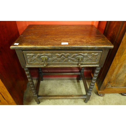 10 - A 17th Century style carved oak single drawer side table