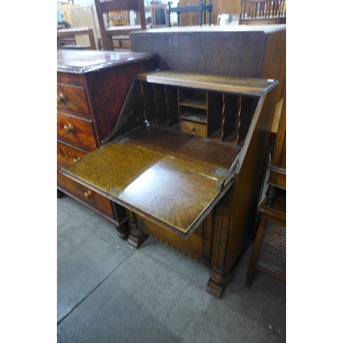 126 - An Art Deco carved oak bureau