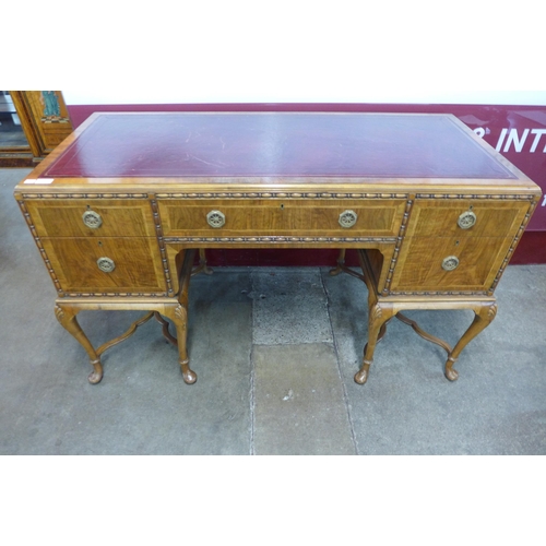 14 - A George I style inlaid walnut and red leather topped writing table