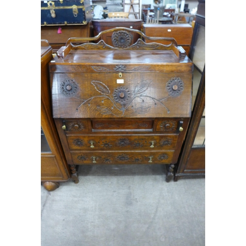 179 - A carved oak bureau