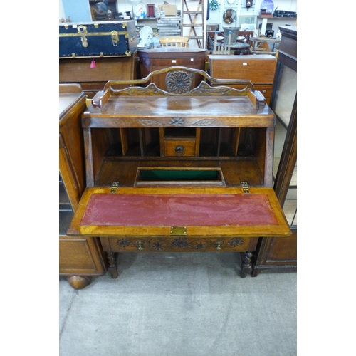 179 - A carved oak bureau