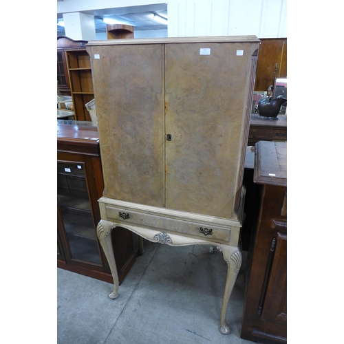 187 - A Queen Anne style walnut cocktail cabinet on stand