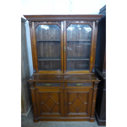 195 - A Victorian Aesthetic Movement carved oak bookcase