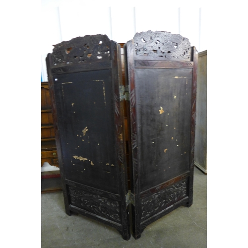 199 - A Chinese ebonised and relief work folding dressing screen