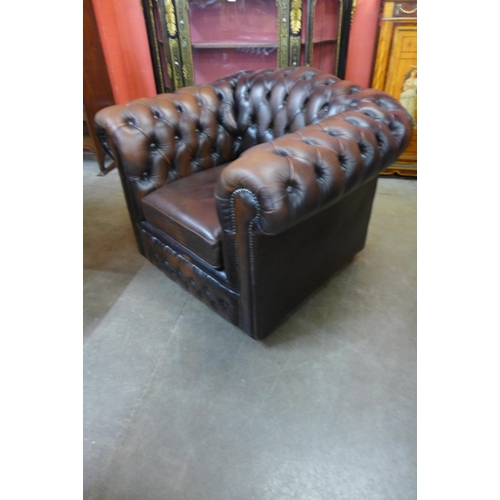 21 - A brown leather Chesterfield club chair