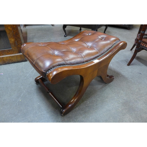 23 - A mahogany and brown leather footstool