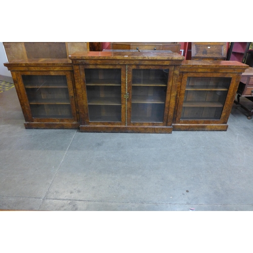 34 - A Victorian walnut four door breakfront bookcase, 103cms h, 298cms w, 38cms d