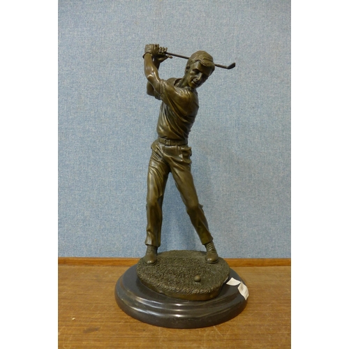 369 - A bronze figure of a golfer, on black marble socle