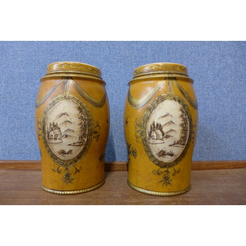 371 - A pair of painted toleware style jars and covers