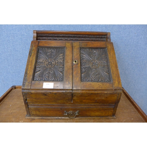 374 - A Victorian Aesthetic Movement carved oak letter and stationery cabinet