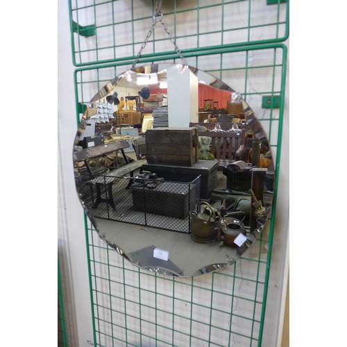 378 - An Art Deco bevelled edge circular mirror