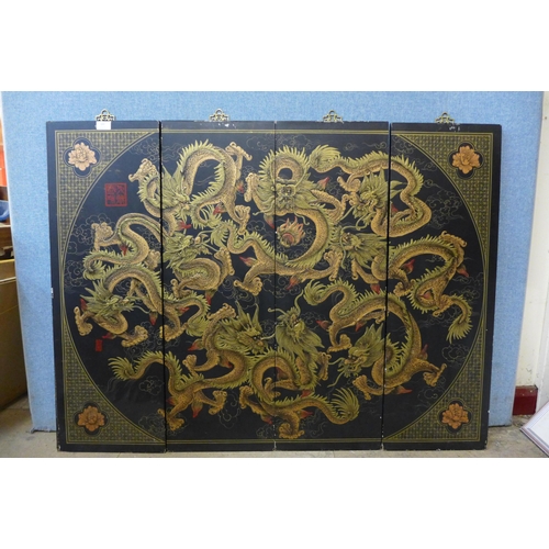 399 - An oriental black lacquered chinoiserie four panel screen