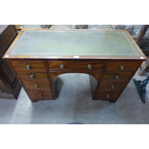 45 - A George IV mahogany and green leather topped kneehole desk