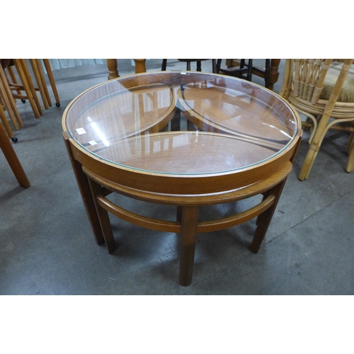 68 - A Nathan teak and glass topped circular nest of tables