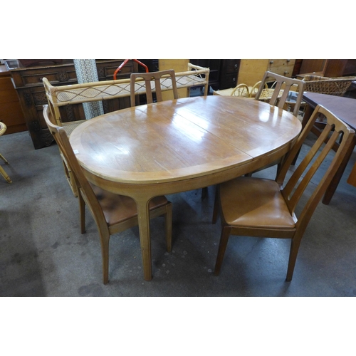 82 - A Nathan teak extending dining table and four chairs