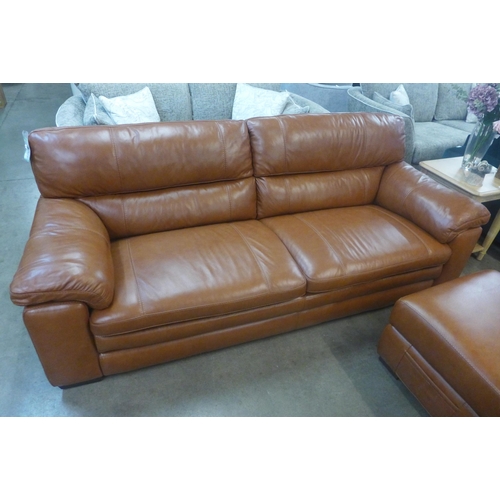 1301 - A designer tan leather three seater sofa and footstool/ottoman