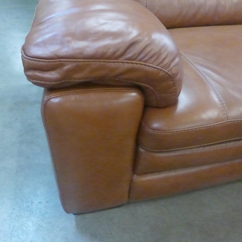 1301 - A designer tan leather three seater sofa and footstool/ottoman