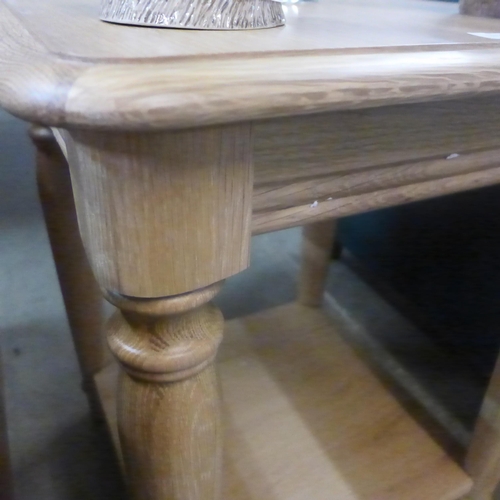 1310 - An oak two tier side table with turned supports*This lot is subject to VAT