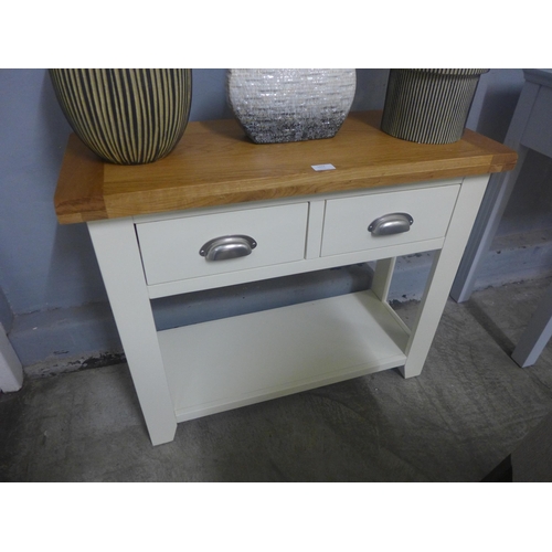 1432 - A cream painted and oak two drawer console table ( Damaged to base, cracked and marked top) *This lo... 