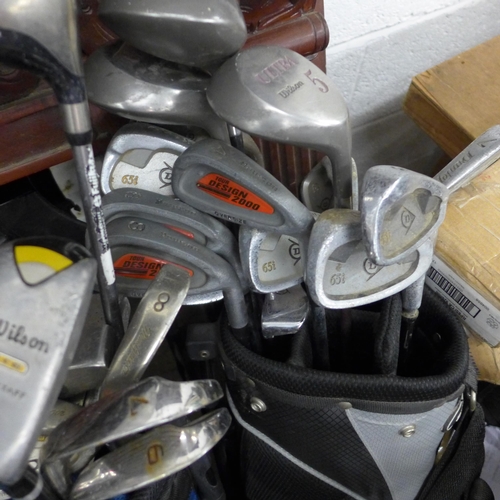 2382 - Six golf bags, two trolleys plus 40-50 golf clubs