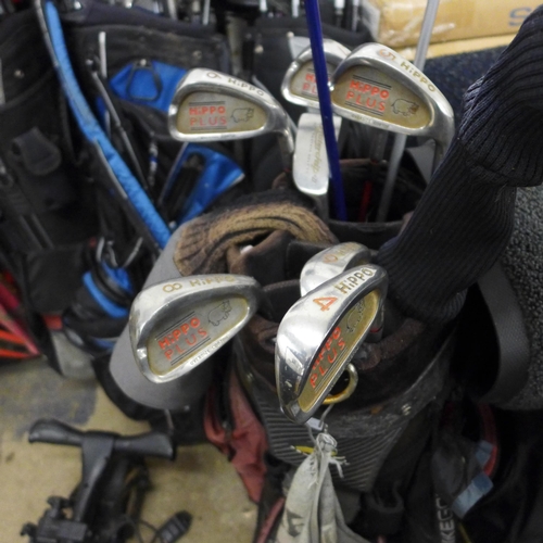 2382 - Six golf bags, two trolleys plus 40-50 golf clubs