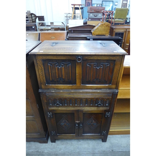 119 - A carved oak cocktail cabinet