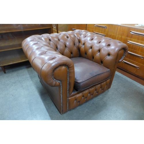 139 - A brown leather Chesterfield club chair