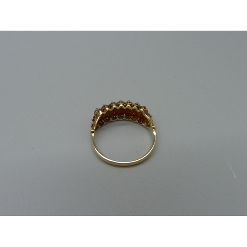 1082 - A 9ct gold, fourteen stone, two row coral ring, 2g, P