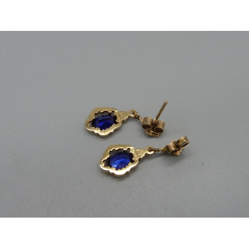 1083 - A pair of 9ct gold and blue stone earrings, 2.7g