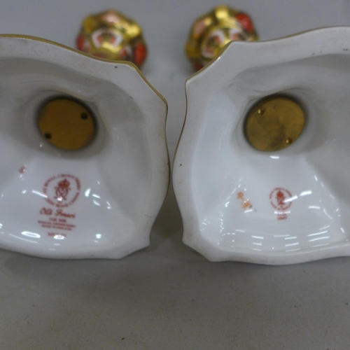 603 - A pair of Royal Crown Derby Old Imari candlesticks, one with small hairline to base, 17.5cm