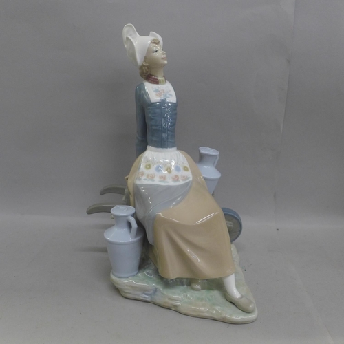 612 - A large Lladro figure, Milkmaid with Wheelbarrow, 32cm