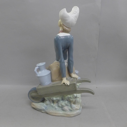 612 - A large Lladro figure, Milkmaid with Wheelbarrow, 32cm