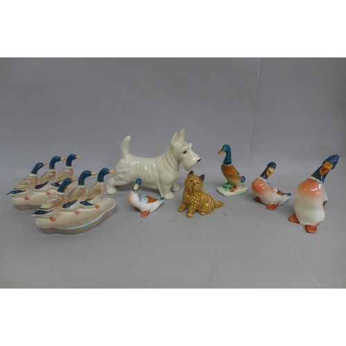 630 - A collection of Beswick and other ducks, one a/f, a Wade dog and one other model of a dog