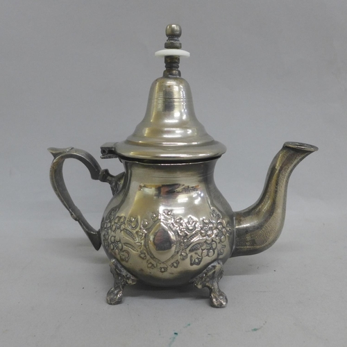 643 - A Middle Eastern silver plated pouring pot