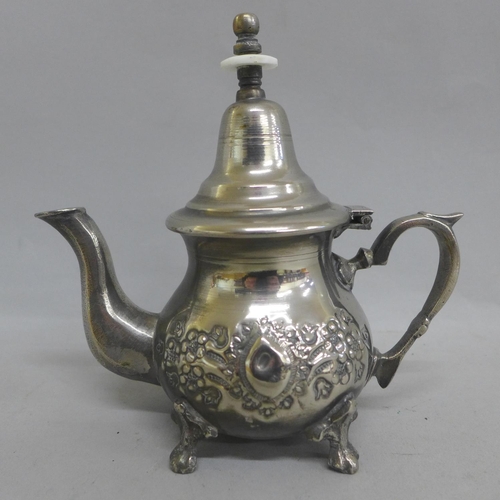 643 - A Middle Eastern silver plated pouring pot